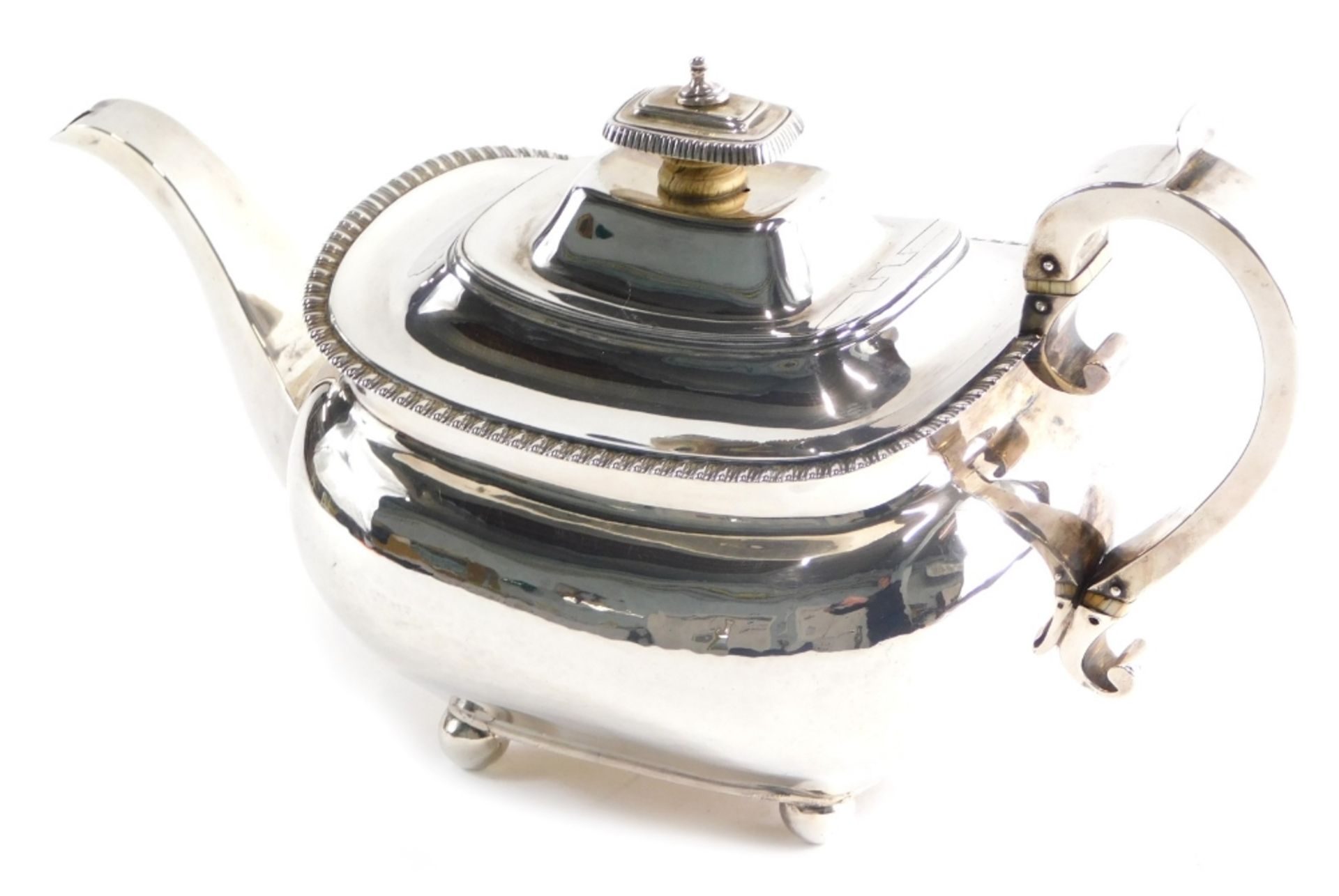 A George III silver teapot, by Thomas Johnson, of cape form with scroll handle, on orb feet, London