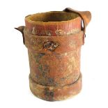 A leather artillery shell carrier, of cylindrical form with handle, with partial crest in colours, 3