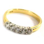 A 18ct gold diamond five stone dress ring, set with five round brilliant cut diamonds, each approx 0