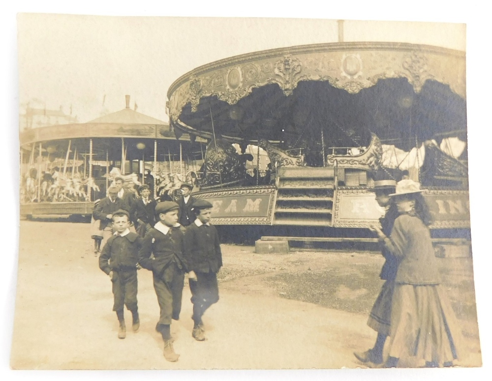 A 20thC Lincoln city postcard, small size, children before carousel, presumably Lincoln Fair, handwr