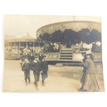A 20thC Lincoln city postcard, small size, children before carousel, presumably Lincoln Fair, handwr