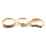 Three dress rings, comprising a wish bone ring with missing stone, yellow metal stand 9ct, a 9ct gol