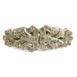 An Art Deco style brooch, set with paste stone formed as two belt clips, with single pin back, 5cm d