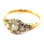 An Edwardian diamond set dress ring, set with old cut diamonds, with central floral cluster the larg