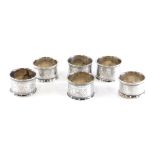 Six various silver napkin rings, each chased with leaves and scrolls, Birmingham 1925, 1921, etc., 5