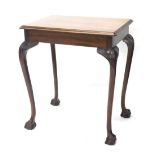 A mahogany side table, the rectangular top raised above heavily carved cabriole legs terminating in
