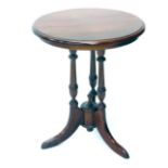 A mahogany occasional table, the circular top on triple turned supports terminating in sabre legs, 6