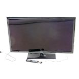 A Samsung UE46D5320 42" flat screen television, on stand, with remote control and wire.