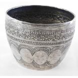 An Eastern hammered bowl, with ribbed and engraved design, white metal unmarked, 4.61oz, 7cm high.