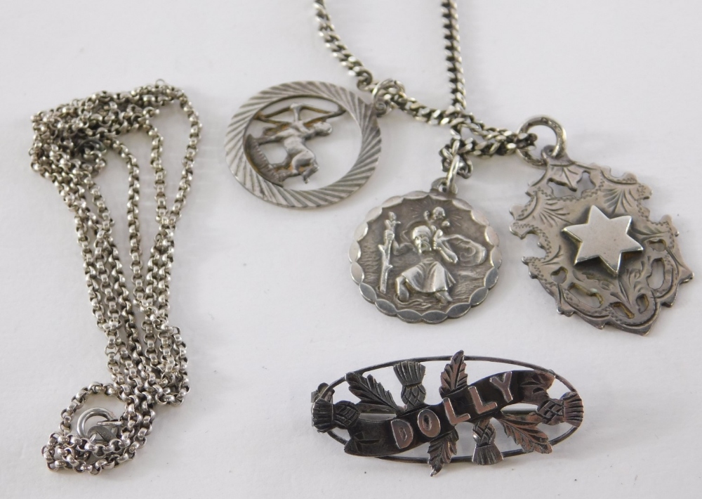 A group of silver jewellery, comprising silver St. Christopher pendant and chain, a silver circular