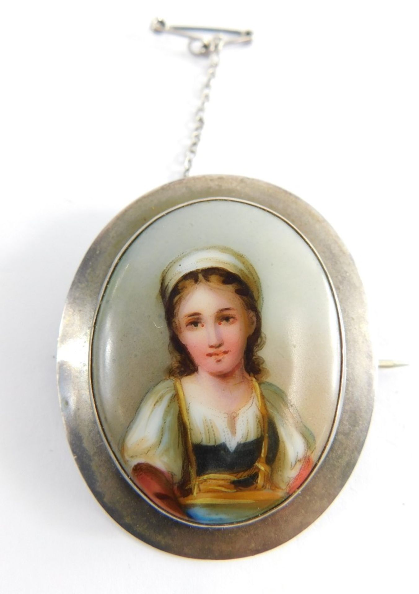 A late 19th/early 20thC portrait brooch, the oval hand painted portrait of young female in gown, in