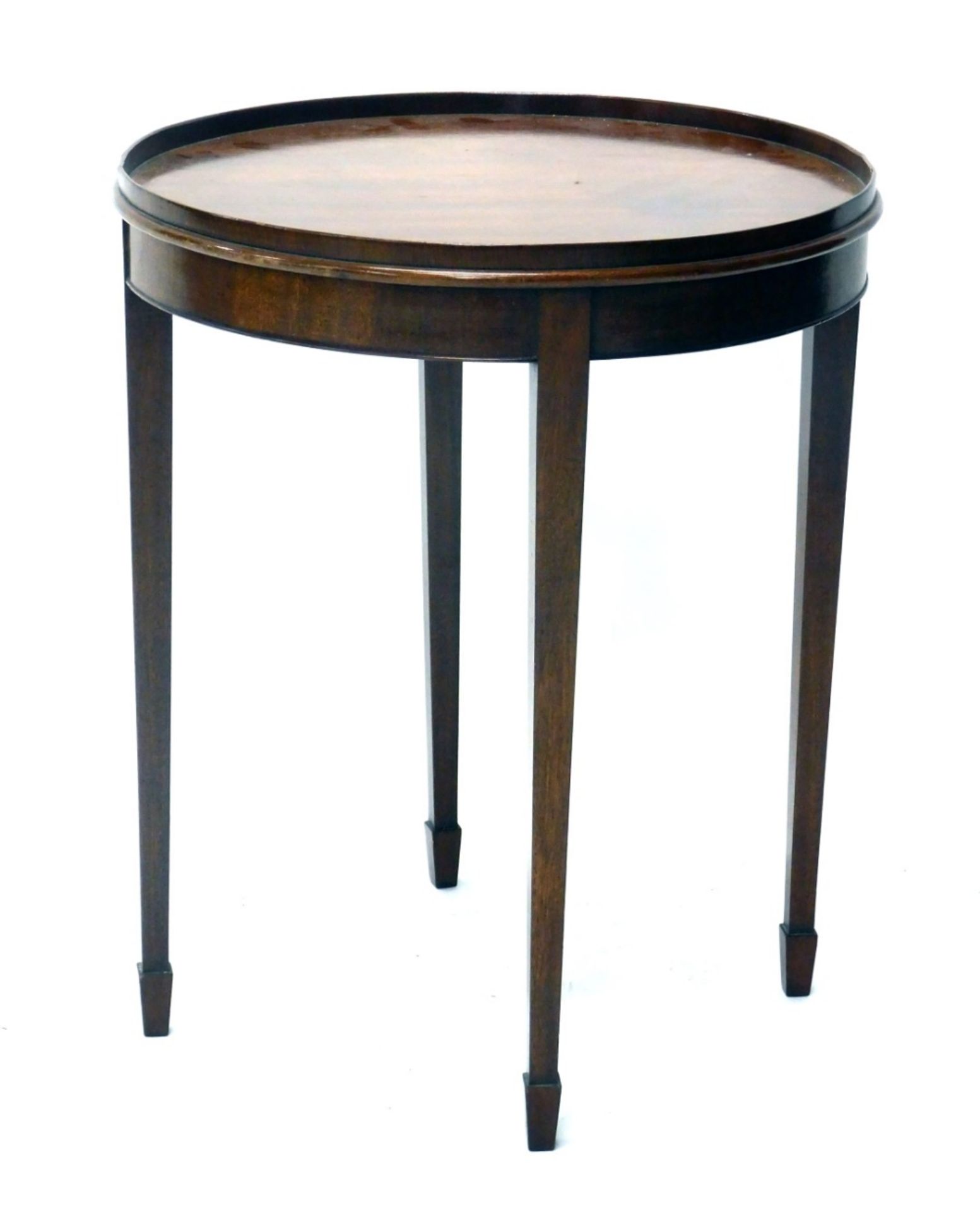 An early 20thC mahogany occasional table, the circular galleried top raised on square tapering legs