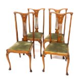 A set of four Edwardian mahogany and boxwood strung Sheraton revival dining chairs, with comb top ra