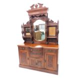 A late 19thC walnut mirror back sideboard, with two drawers and cupboards flanked by further drawers