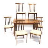A teak G-Plan style extending dining room table and six chairs, overstuffed in cream material, the t