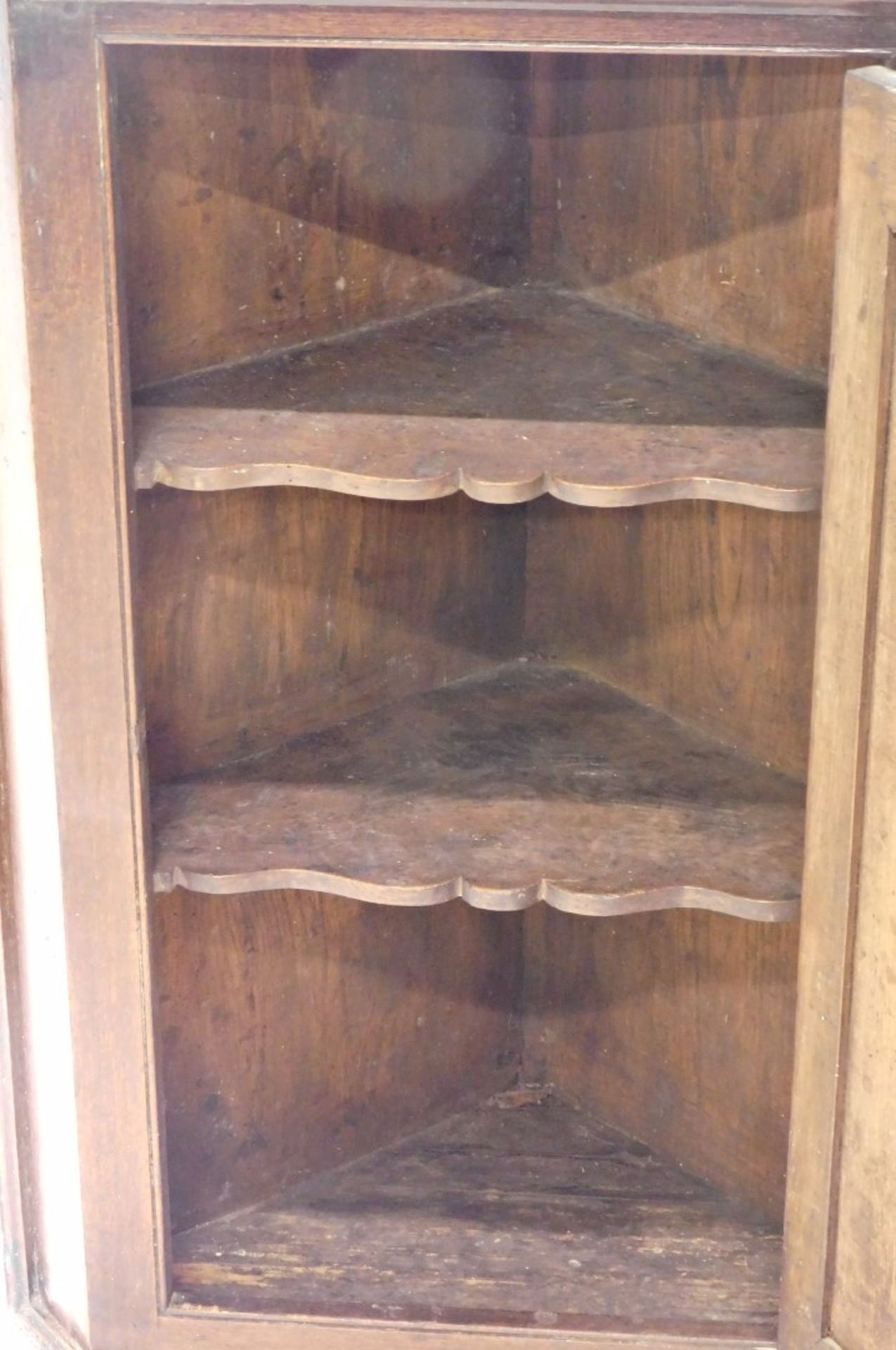 A late 18thC oak hanging corner cabinet, the panelled door revealing a fitted interior, with two she - Image 2 of 2