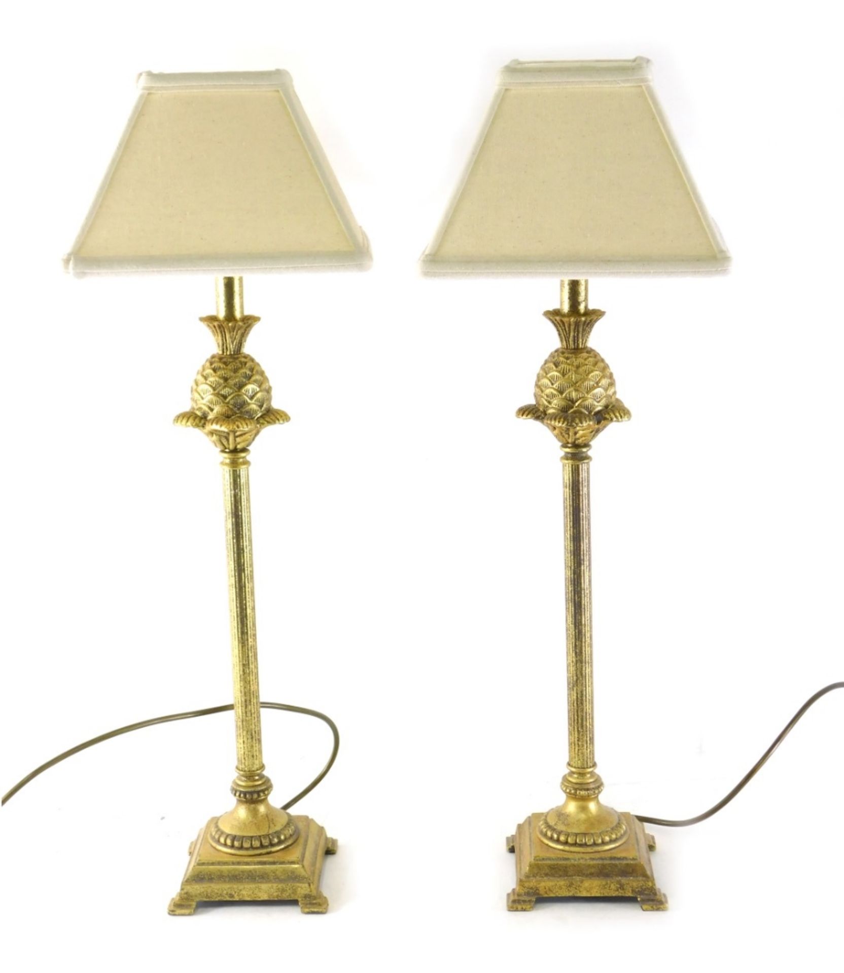 A pair of gilt metal table lamps, with pineapple and fluted stems terminating in step bracket feet w