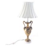 A classical design urn table lamp, with double strap work handles, with a mask head and raised cher