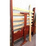 A pine kingsize bed frame, with headboard, footboard, and supports.