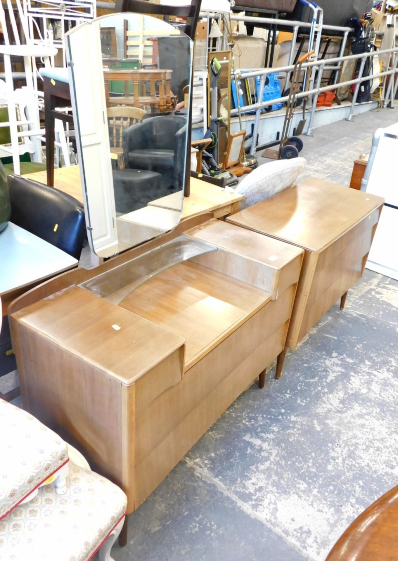 A walnut finish retro mirror back dressing table and chest of drawers.