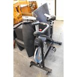 A JTX Fitness exercise bike and mat