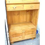 A pine open cabinet, with two drawers above open shelved double cupboard beneath, on bun feet.