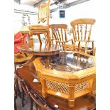 An oval mahogany finish coffee table, heavily carved oak chair, with overstuffed back and seat, furt