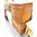 A serpentine chest of four long drawers, and an oak chest of three drawers.