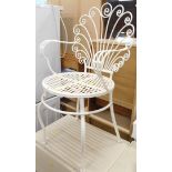 An iron scroll back chair in white, with pierced seat.