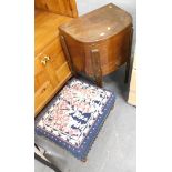 An overstuffed footstool, and an oval side cabinet.