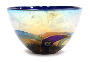 A Michael Harris Isle of Wight glass 'Nightscape' bowl, decorated with iridescent trails against a b