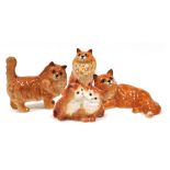 Four Beswick pottery figures modelled as ginger cats, and kittens, in varying positions, seated and
