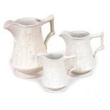 A set of three Portmeirion parian ware graduated jugs, from the British Heritage Collection, each de