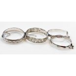 Two silver and foliate engraved bangles, each on a snap clasp with safety chain, a faceted silver ba