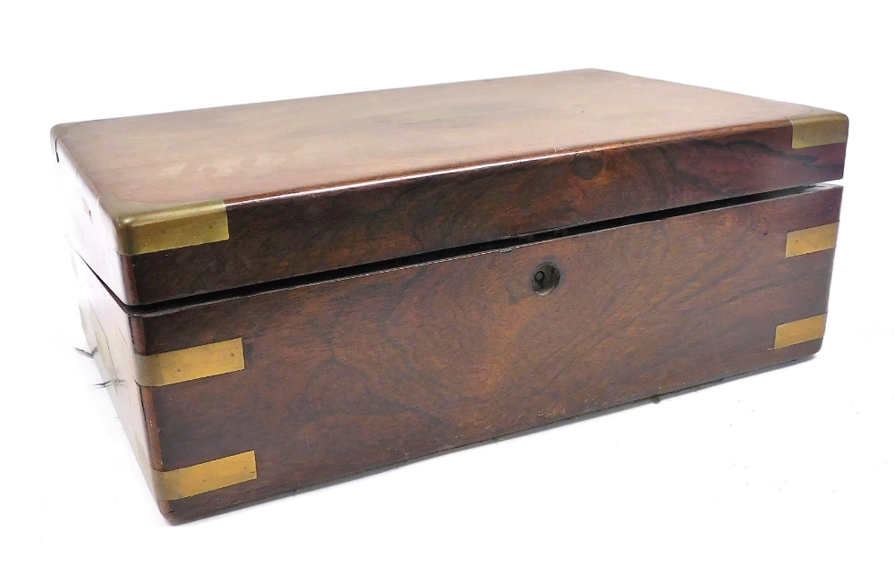 A Victorian walnut and brass bound writing slope, the hinged lid opening to reveal a slope and fitte