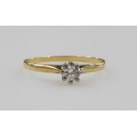 A diamond solitaire ring, in a high claw setting, in yellow metal stamped 18ct, approximately 0.25ct