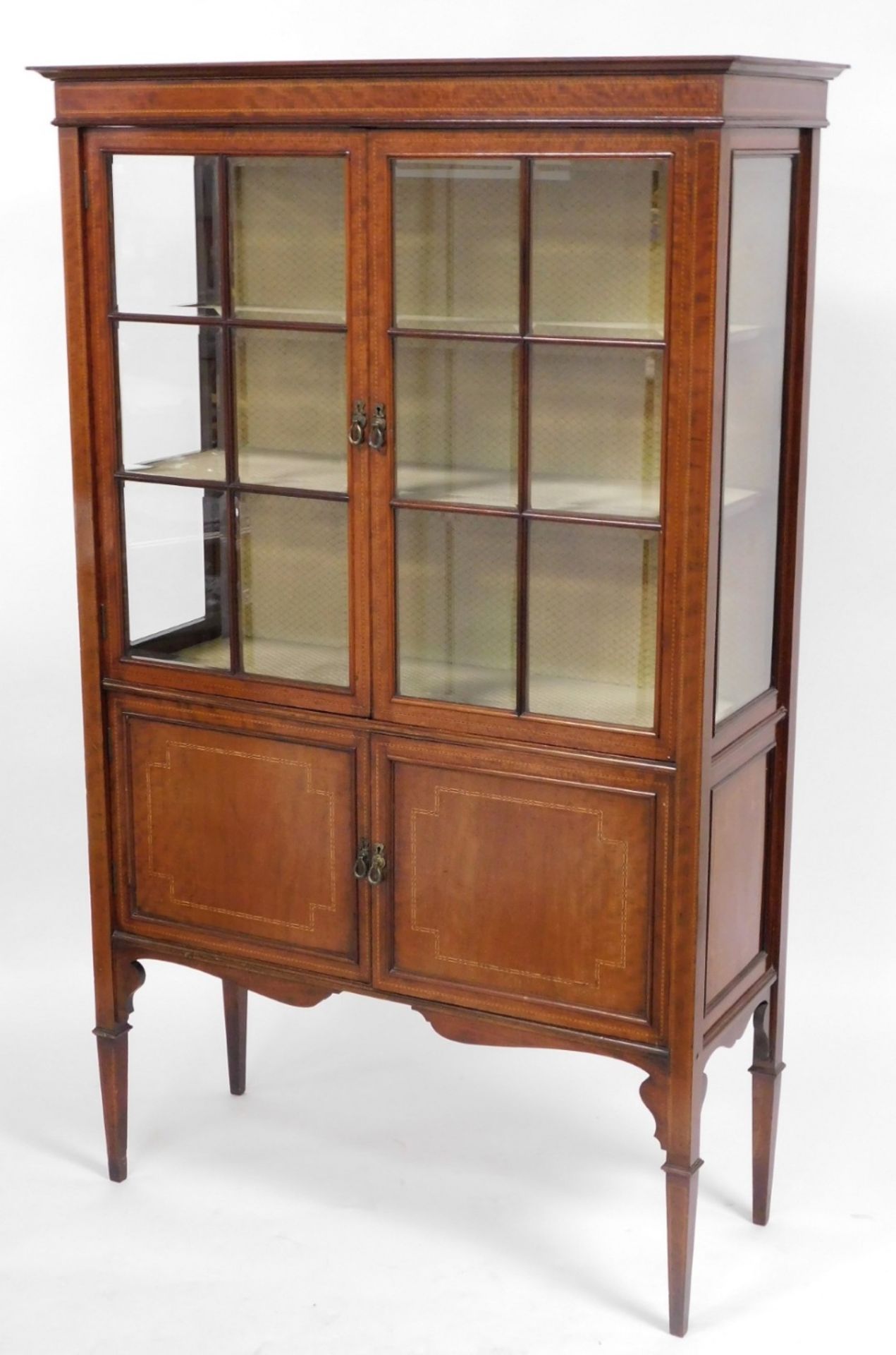 An Edwardian mahogany and line inlaid display cabinet, the out swept pediment over a pair of astraga