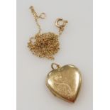 A 9ct gold heart shaped photo locket, with engraved foliate decoration, and a 9ct gold belcher link