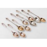 Nine Danish silver coffee spoons, comprising a set of five Simon Groth spoons, each with an intricat