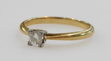An Art Deco diamond solitaire ring, in a square claw setting, in yellow and white metal, stamped 18c
