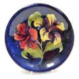 A Moorcroft Hibiscus pattern pottery dish, impressed marks bearing signature and paper label to unde
