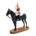 A Beswick Connoisseur model of Lifeguard, a trooper in mounted review order dressed for ceremonial d