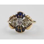 A lady's dress ring, set with sapphires and clear stones, possibly white sapphires, in a floral sett