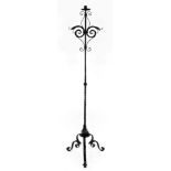 A Victorian cast iron standard candle holder, raised on three scroll legs, 161cm high.