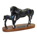 A Beswick Connoisseur model of Black Beauty and foal, on an oval hardwood base, 20cm high.