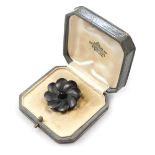 A late 19thC German black floral brooch, possibly jet, set in white metal, in a fitted box, for the