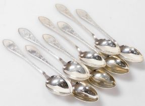 A set of eight Meyer Danish silver dessert spoons, foliate engraved, shield reserve monogram engrave