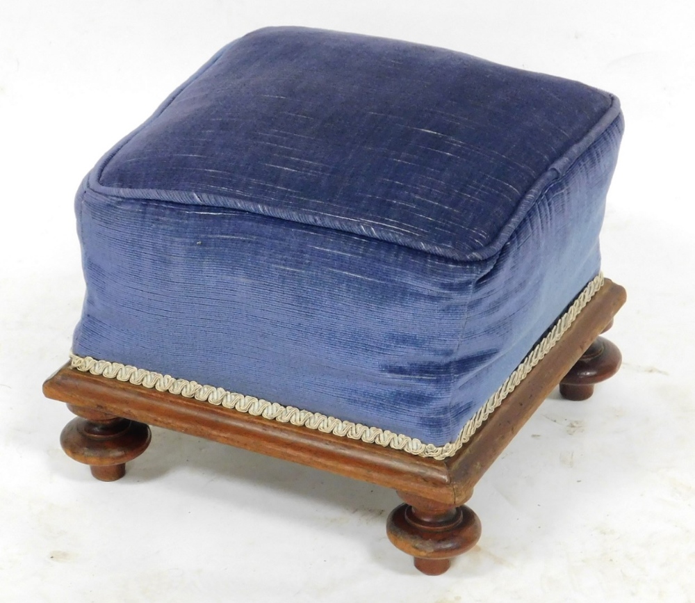 A Victorian mahogany footstool, upholstered in blue draylon, raised on turned feet, 92cm wide.