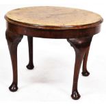 An early 20thC circular walnut coffee table, raised on cabriole legs, 44cm high, 53cm wide.
