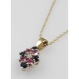 A 9ct gold diamond, ruby and sapphire pendant, in a diamond shaped design, on a belcher link neck ch